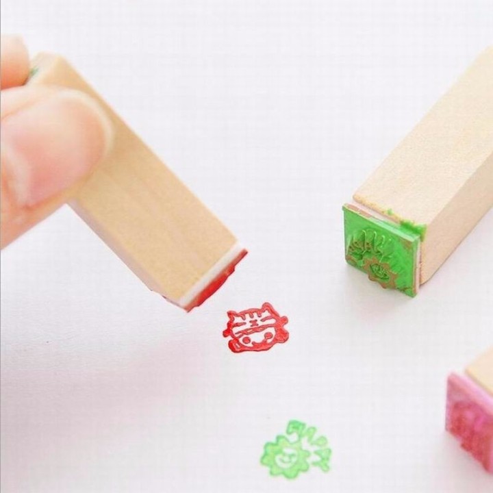 12-piece wooden stamp set with cartoon motifs